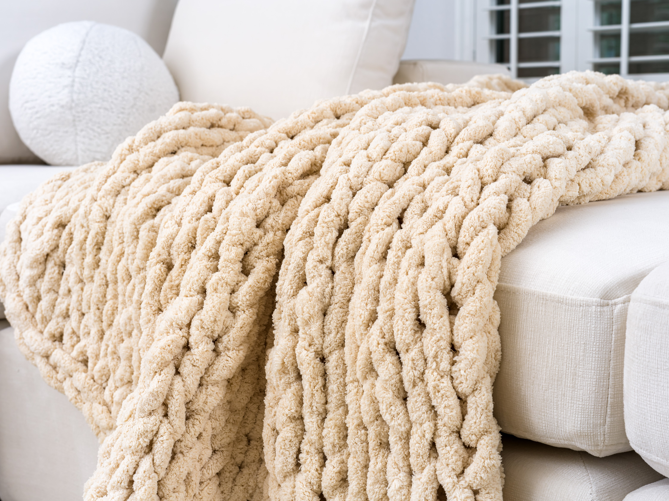 Close-up of tactile textures in home staging, including soft throws